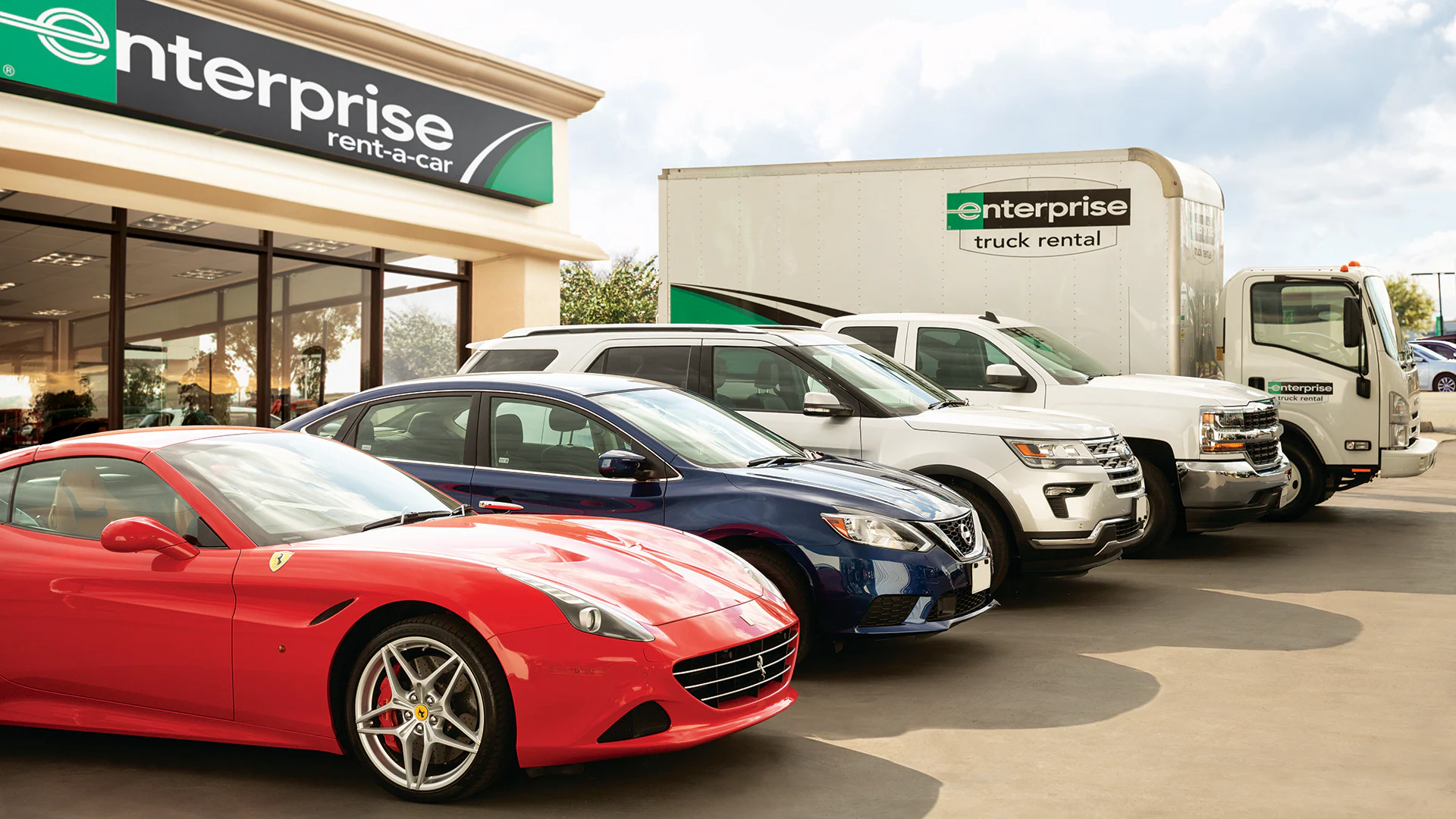 A lineup of vehicles at Enterprise Rental, featuring sports cars, small vehicles, SUVs, and large trucks.