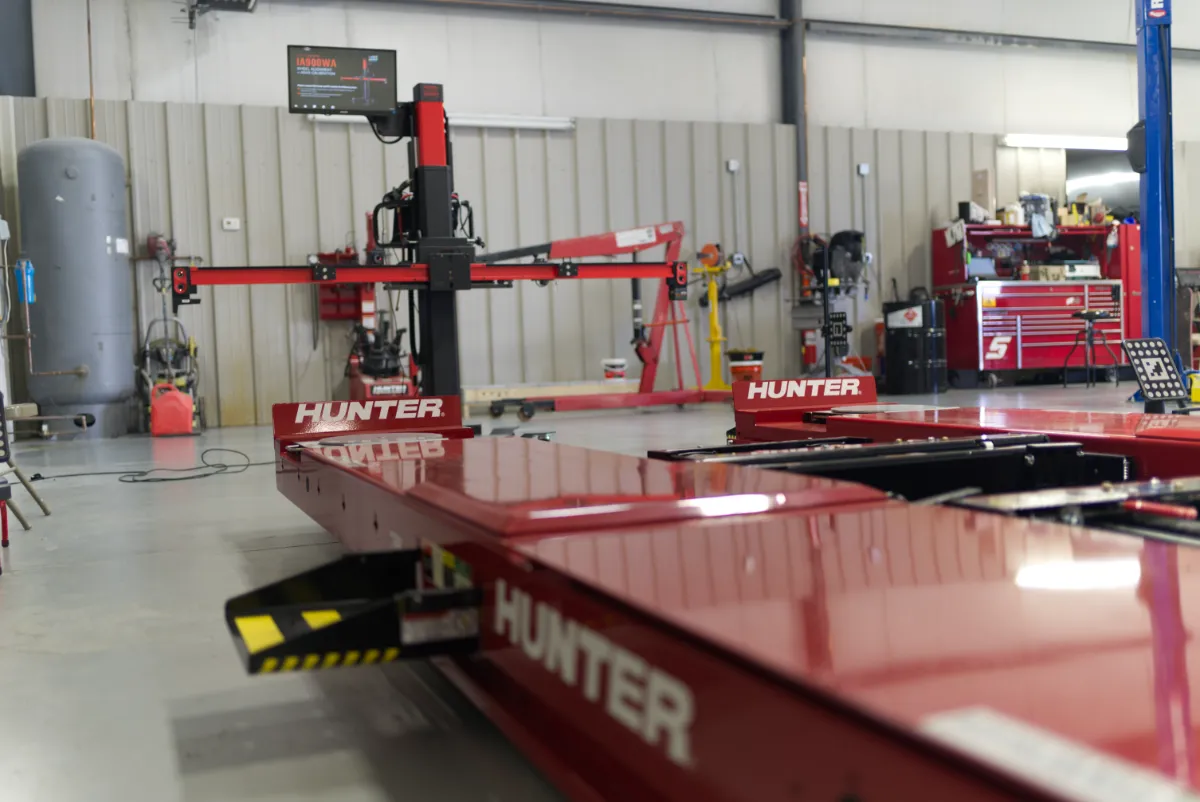 A Hunter alignment rack paired with an Autel calibration frame, showcasing advanced tools for precision repairs and ADAS calibration.